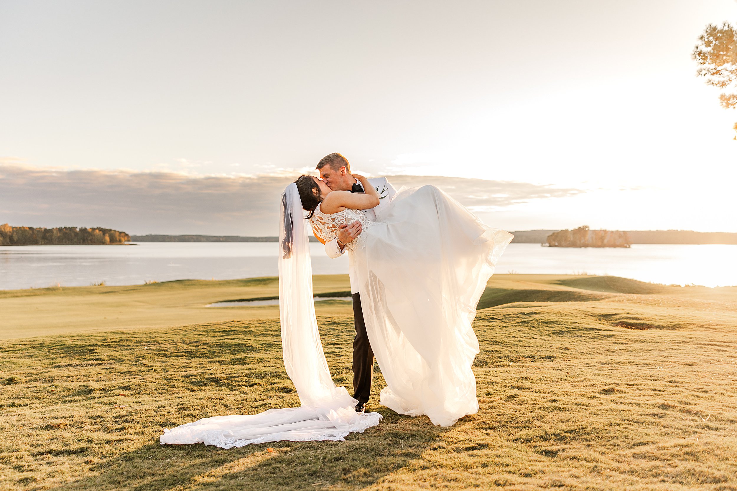 Bride and Groom dip and kiss during sunset at a Old North State Club Wedding